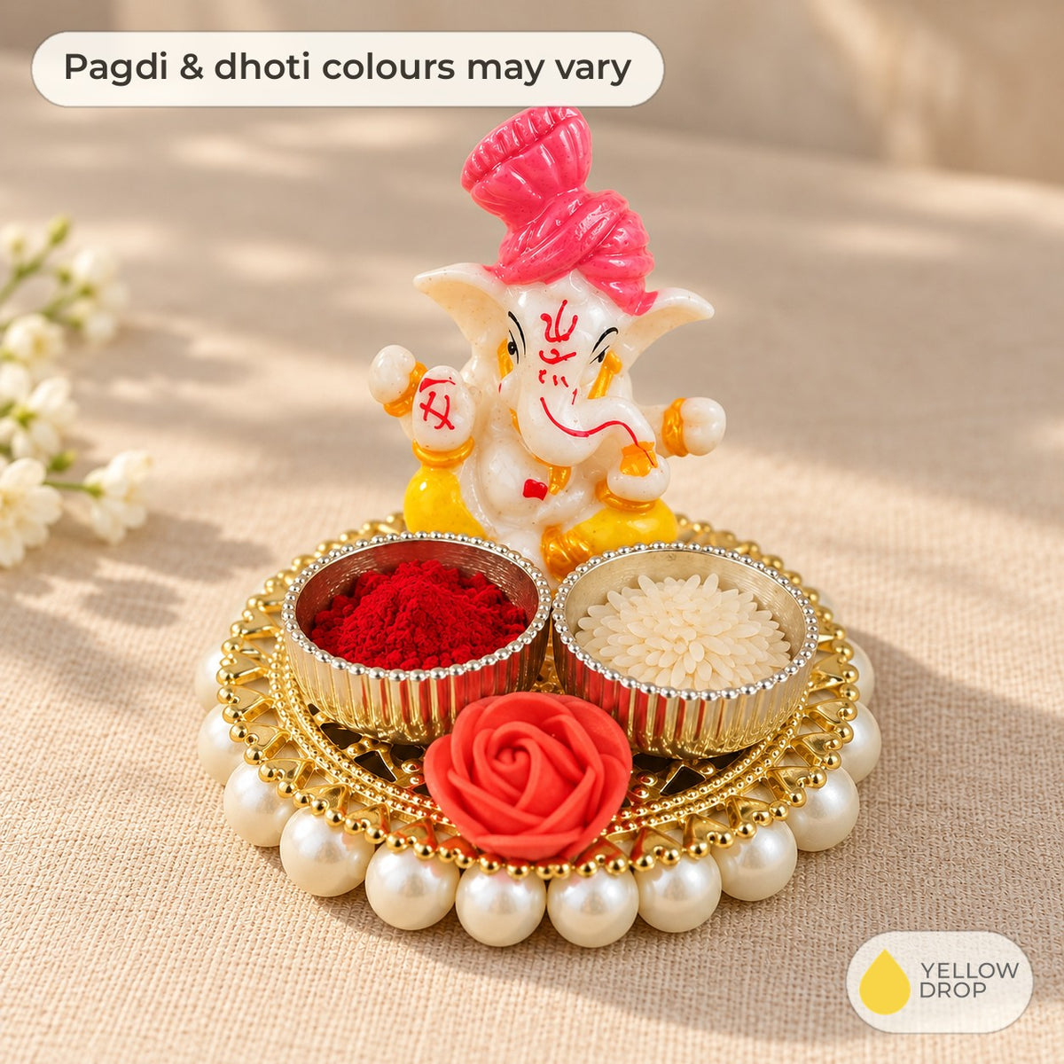 Ganesha kumkum and rice holder with katoris filled