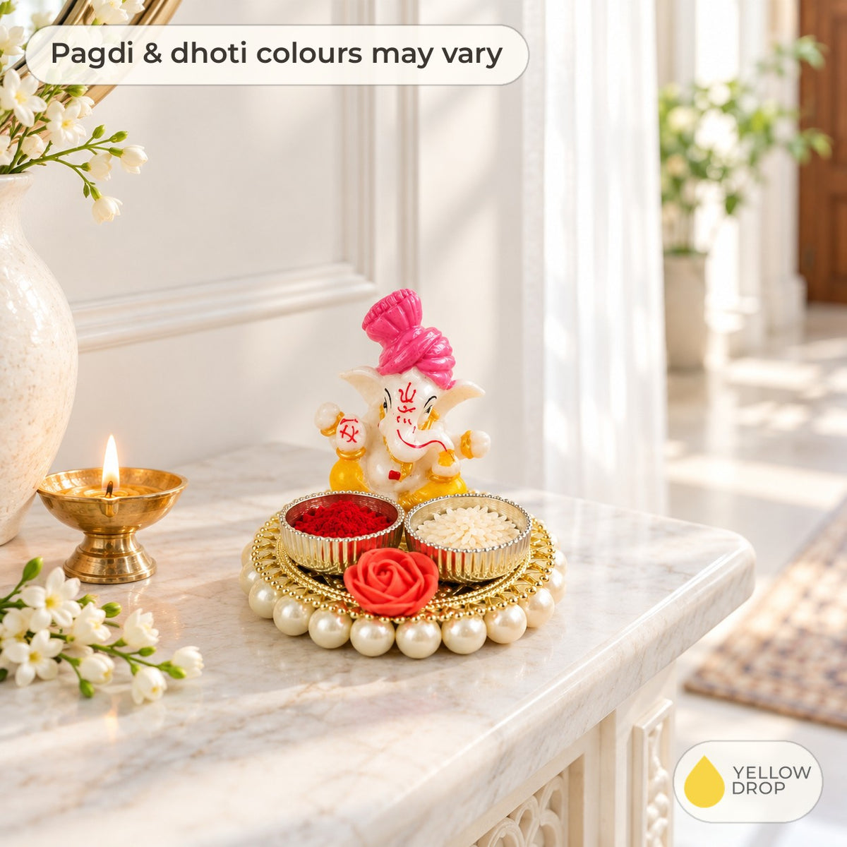 Ganesha kumkum holder on a white marble ledge