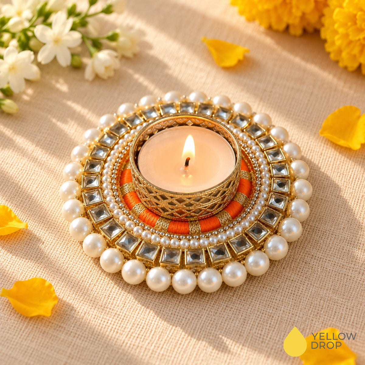Orange Kundan Pearl tealight holder with lit tealight, kundan stones and pearls, jasmine and marigolds