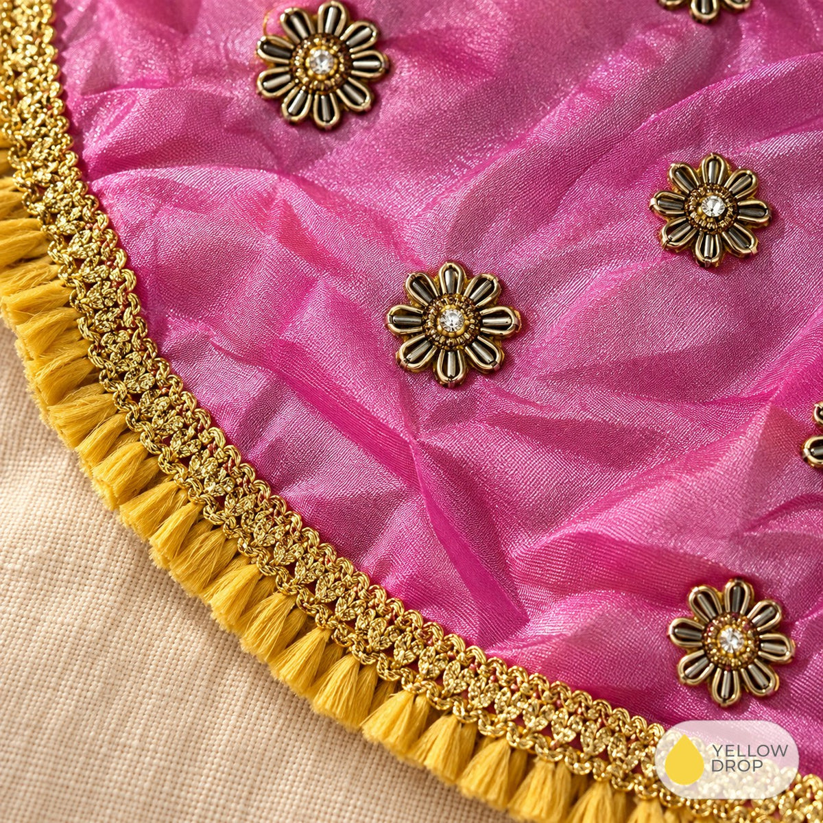 Close-up of metal flower studs and fringed border