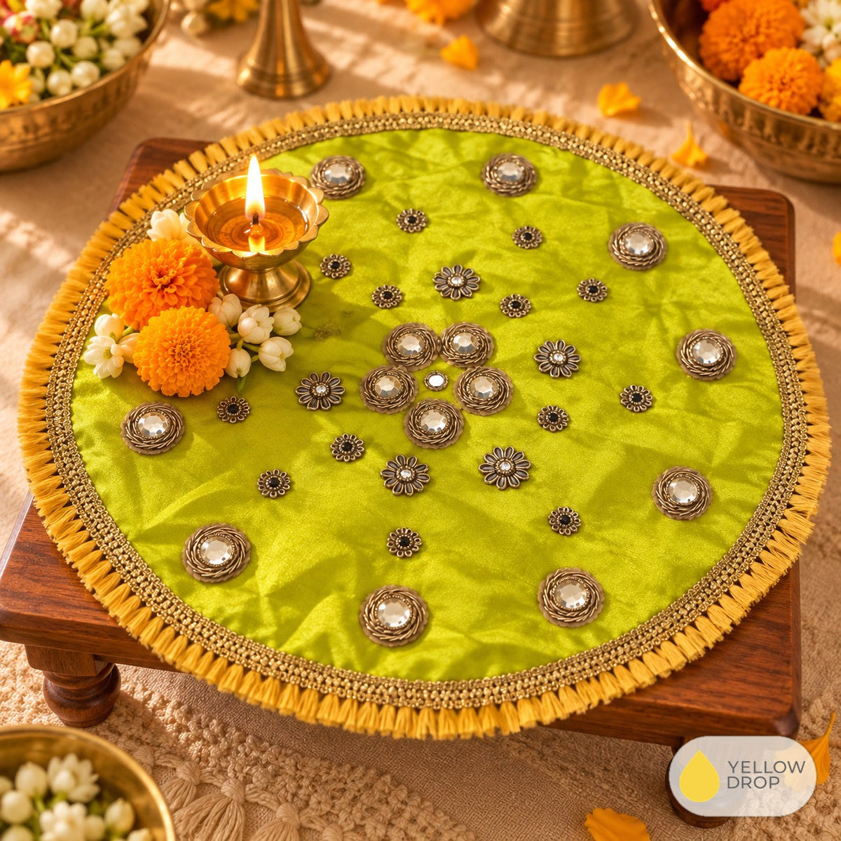Lime mirror pooja cloth on a chowki with diya