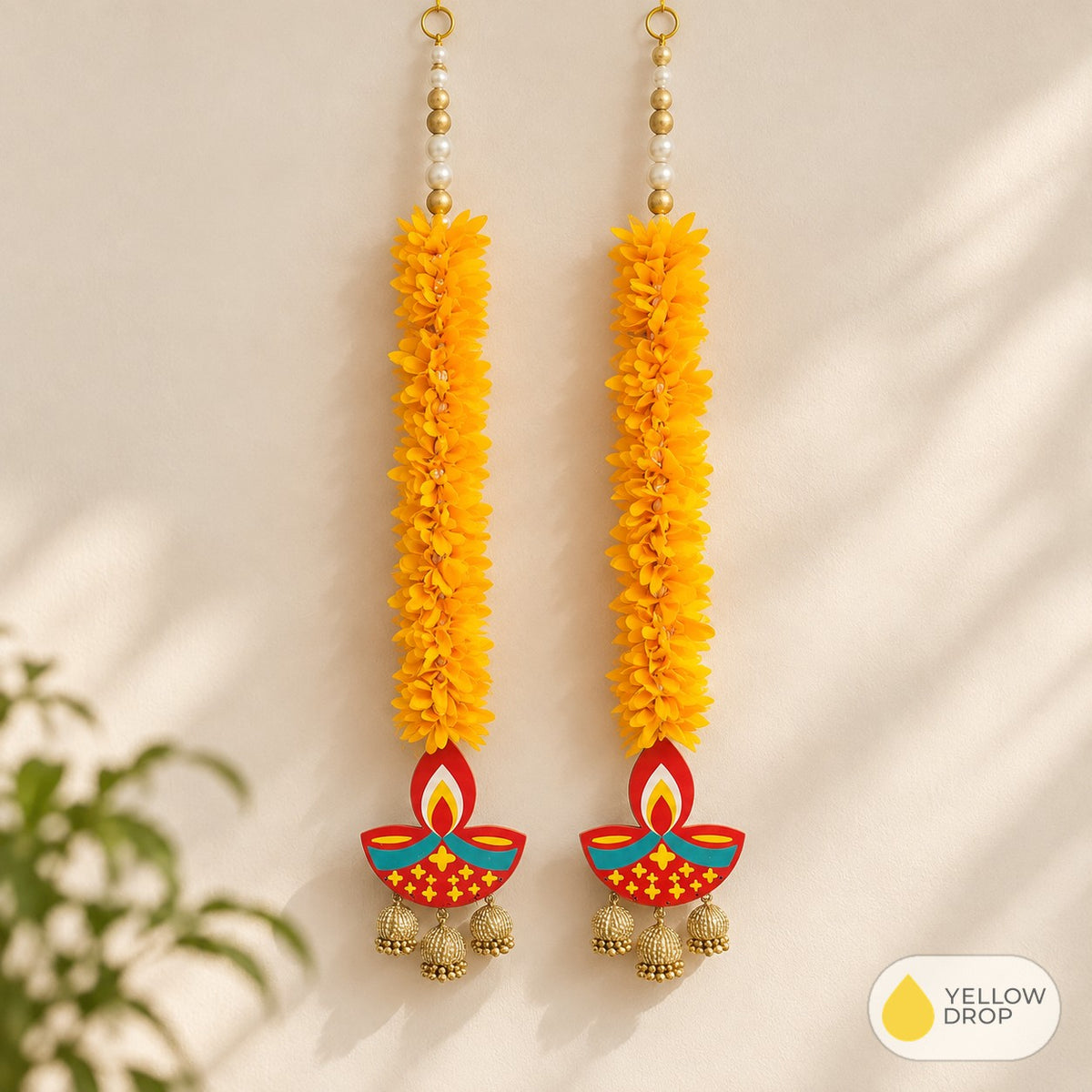 Marigold diya latkan pair on a wall