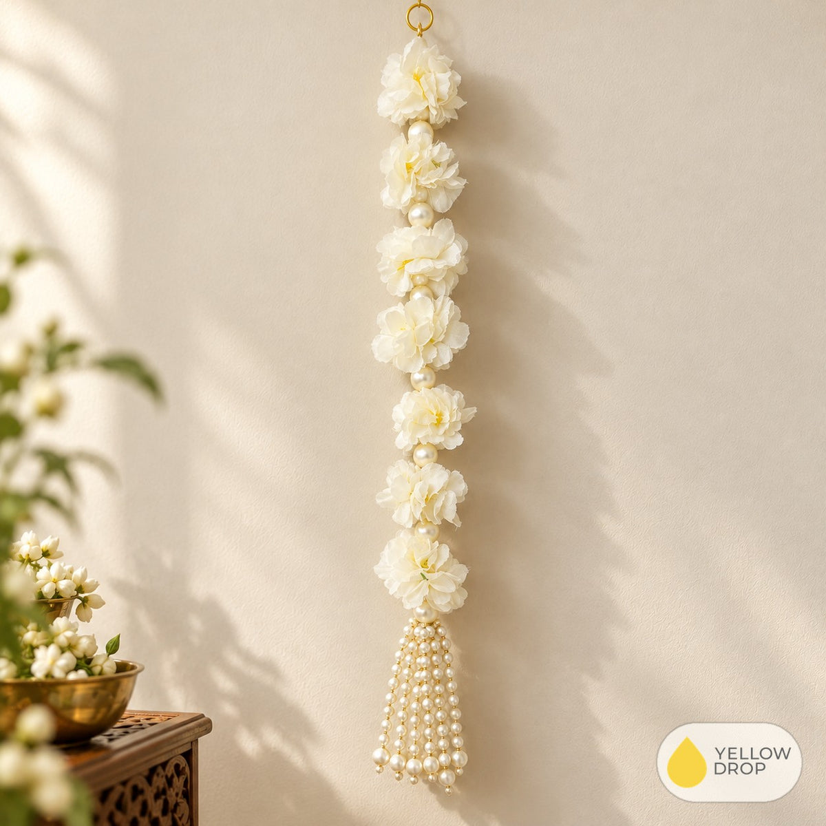 White flower pearl tassel hanging on a wall