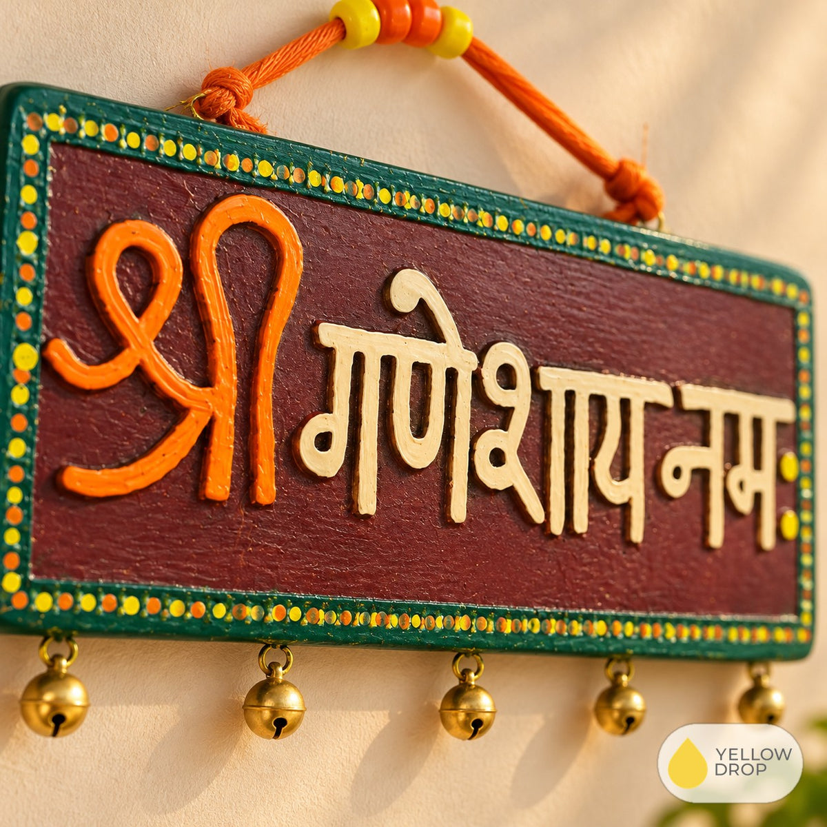 Close-up of painted Devanagari letters and bells
