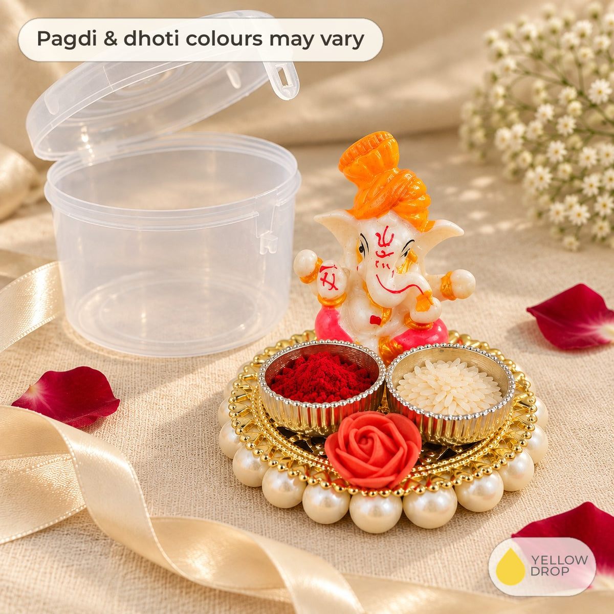 Ganesha with rice and kumkum holder beside its clear gift box