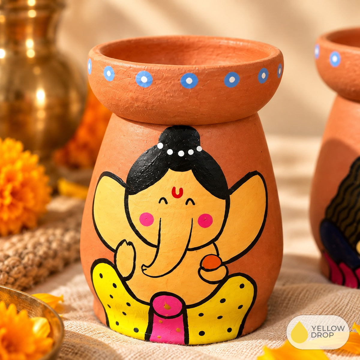 Close-up of hand-painted Ganesha diya pot