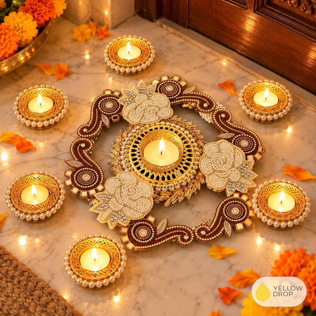 Rangoli tealight set lit at a Diwali entrance
