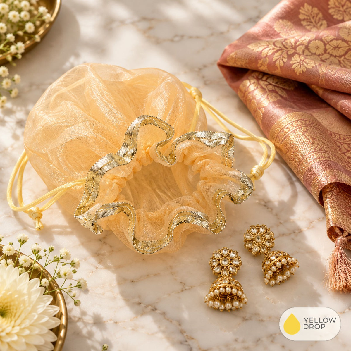 Peach organza potli with gold jhumkas