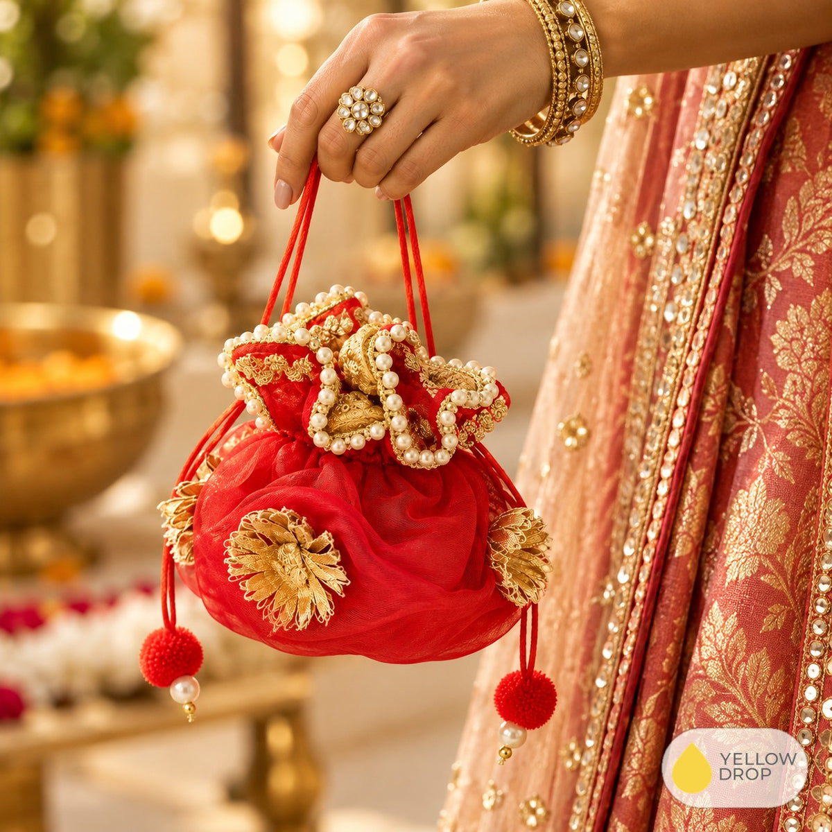 Red gota potli carried with a festive lehenga