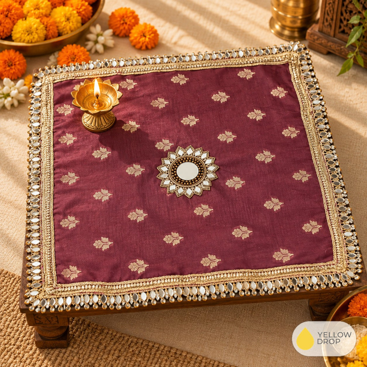 Wine square pooja cloth on a chowki with diya
