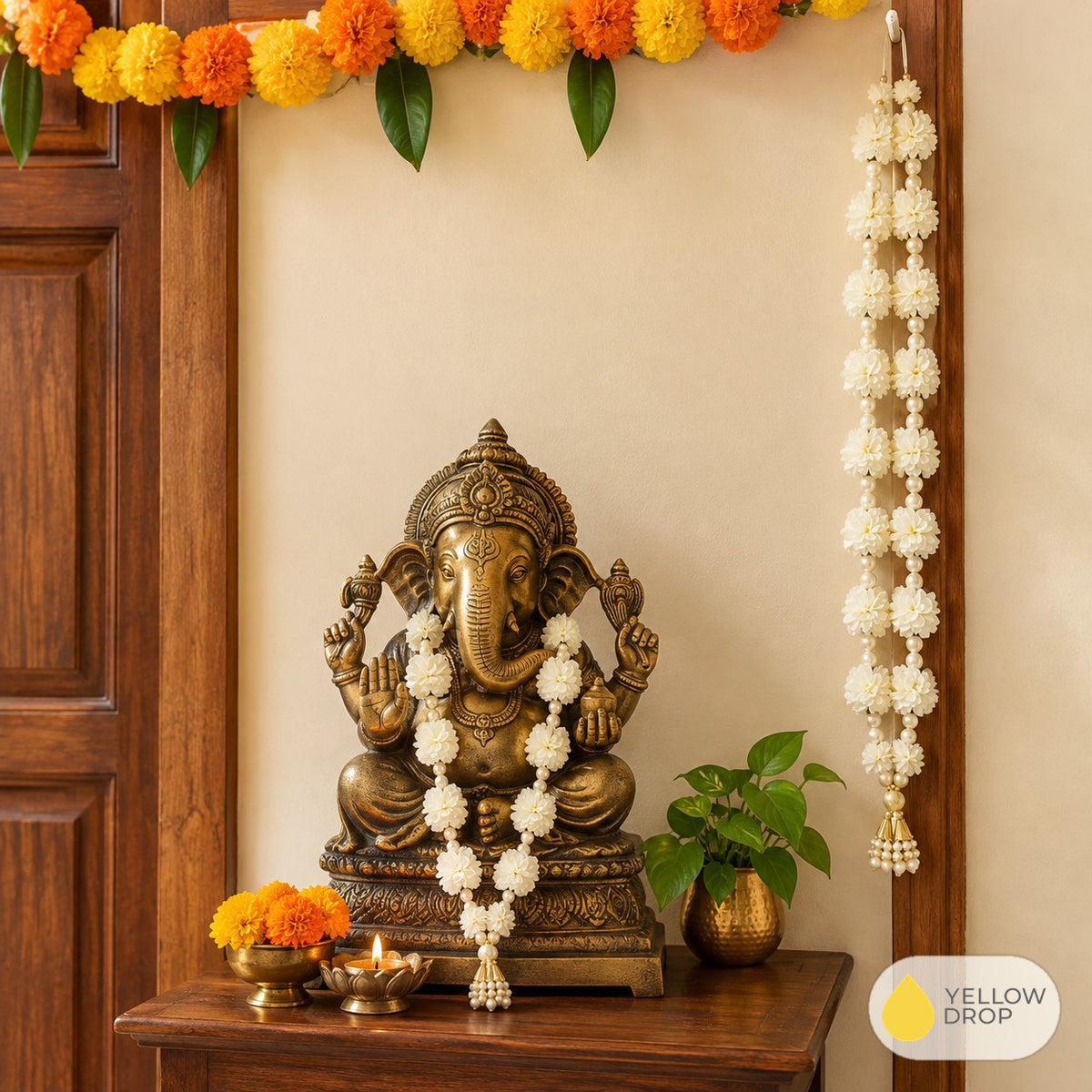 White flower garland beside a Ganesha shrine