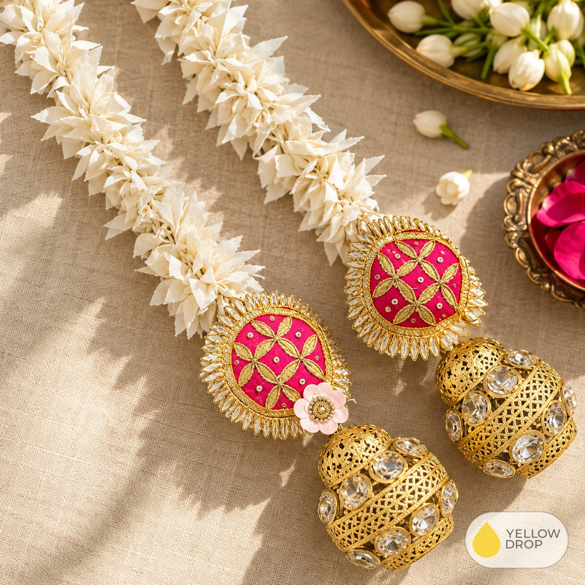 Close-up of pink charm and gold kundan bell