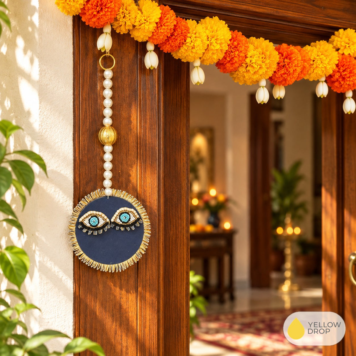 Evil eye hanging on a front door with marigold toran